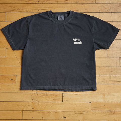 Black t-shirt with 'savannah' text on a wooden floor