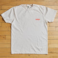 White t-shirt with red tampa text on a wooden floor