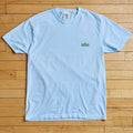 Light blue t-shirt with 'tulsa' text on a wooden floor