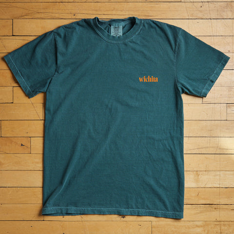 Teal t-shirt with 'wichita' text on a wooden floor